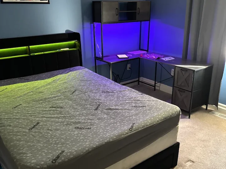 Assembled bed frame and corner desk with storage in a bedroom