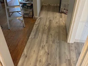 Wood-look flooring laid along a hallway between doorways
